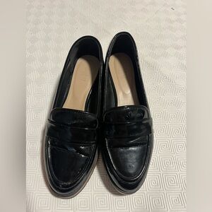 Call It Spring black patent loafers with a chunky sole (platform-style).